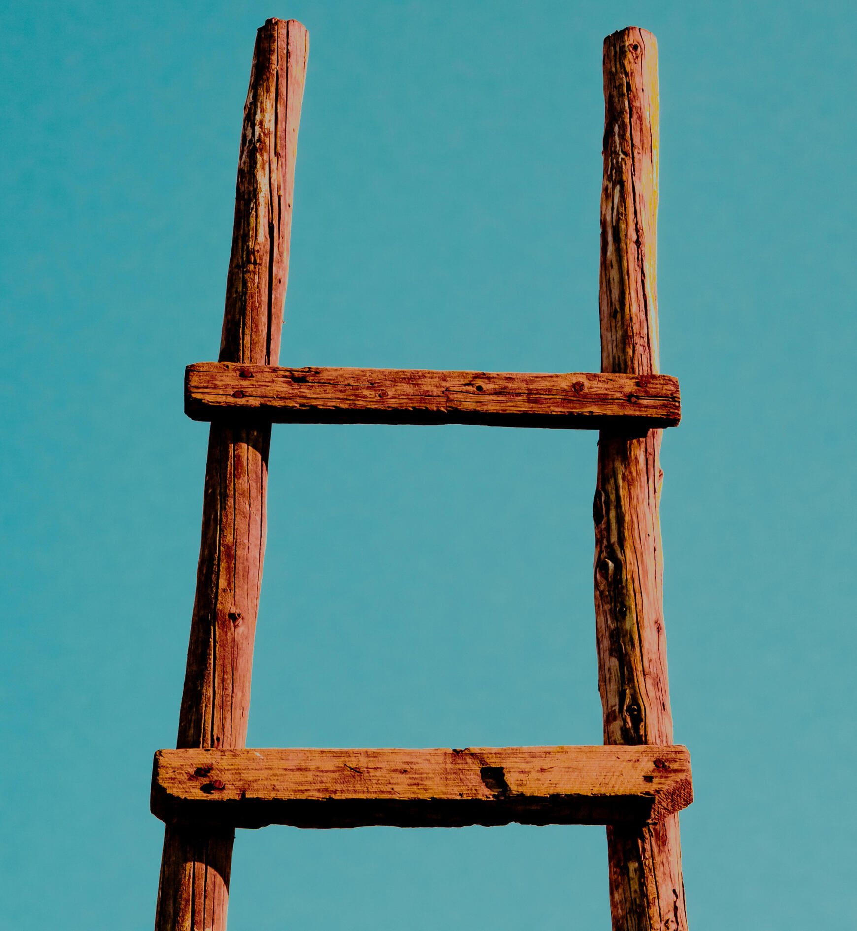 Wooded ladder against a blue wall